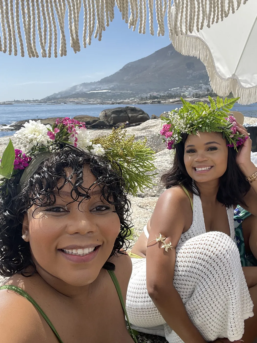 Two friends in flower crowns by the ocean at a Cape Town bachelorette