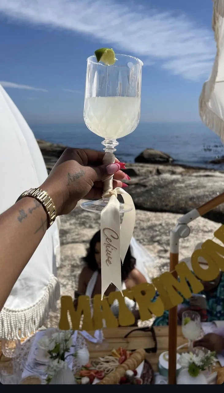 Personalised cocktail raised at a beachside MATRIMONY picnic on the Atlantic Seaboard, Cape Town